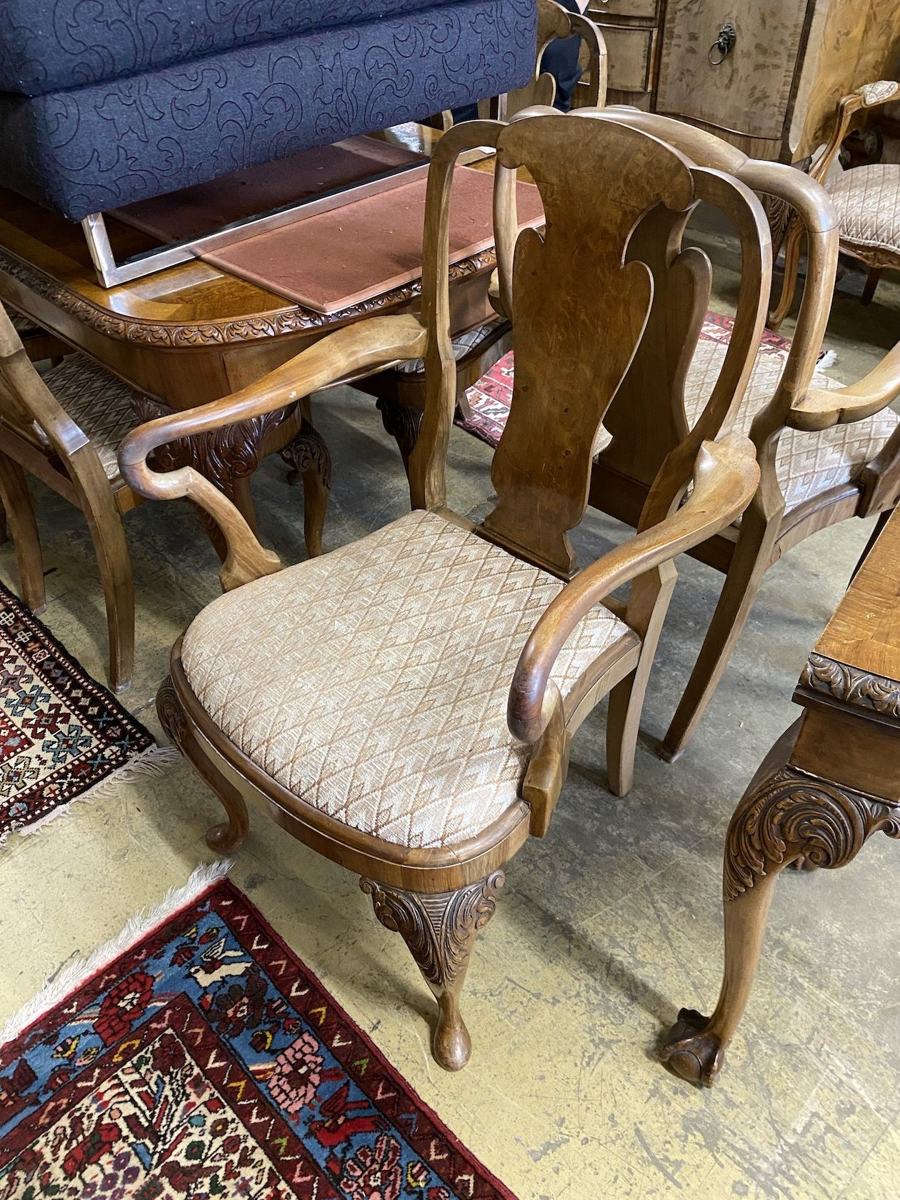 A set of eight Queen Anne revival walnut dining chairs, (two with arms, six single)